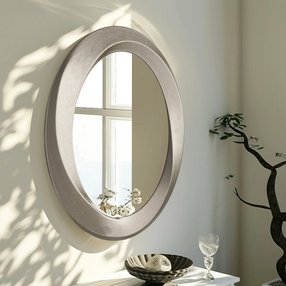 Elegant Oval Wall Mirror Featuring A Beveled Ornamental Frame