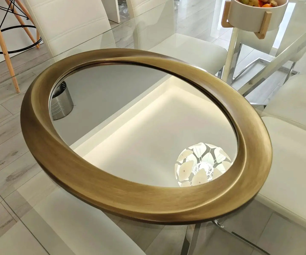Elegant Oval Wall Mirror Featuring A Beveled Ornamental Frame