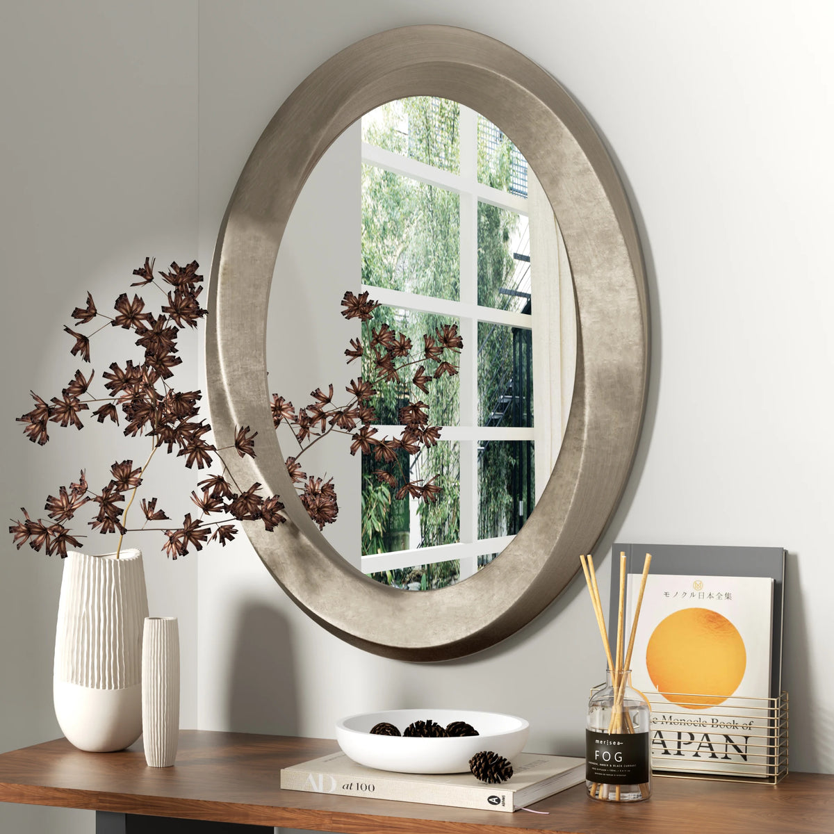 Elegant Oval Wall Mirror Featuring A Beveled Ornamental Frame
